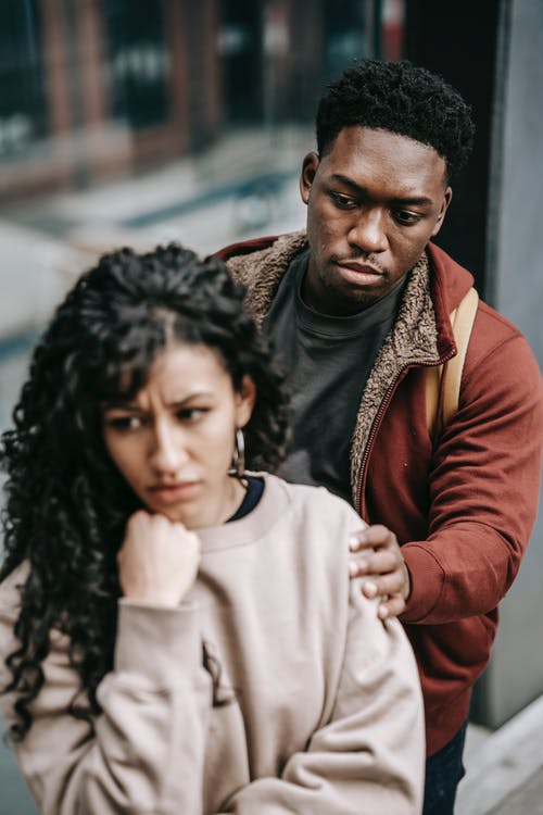 man trying to console woman